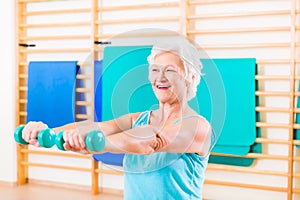 Senior woman doing fitness sport in gym