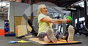 Senior woman doing oblique exercises on exercise mat 4k