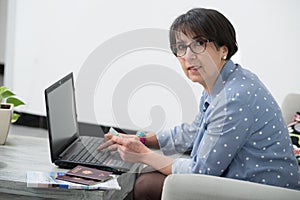 Senior woman doing online shopping