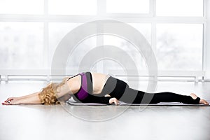 Senior woman doing Sleeping Swan yoga pose