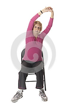 Senior woman doing stretch exercise in chair