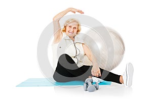 Senior Woman Doing Stretching Exercise On Mat