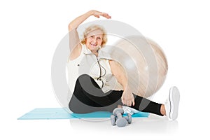 Senior Woman Doing Stretching Exercise On Mat