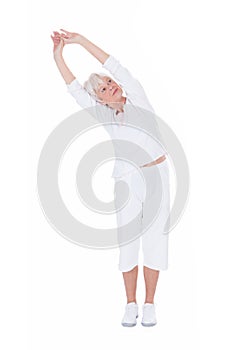 Senior woman doing stretching exercise over white background