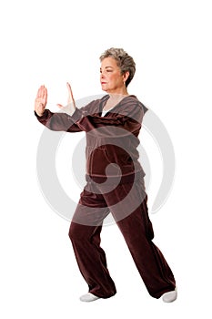 Senior woman doing Tai Chi Yoga exercise photo