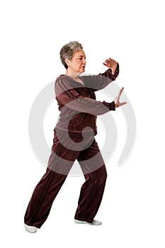 Senior woman doing Tai Chi Yoga exercise