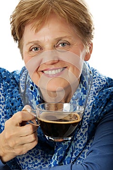 A senior woman drinking a cup of coffee