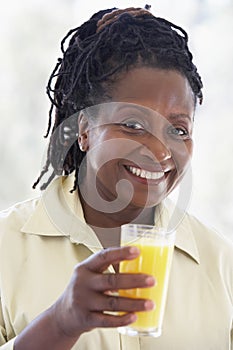 Senior Woman Drinking Fresh Orange Juice