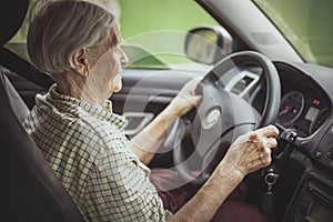 Senior woman driving a car.