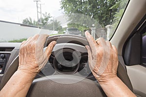 Senior woman driving a car in town