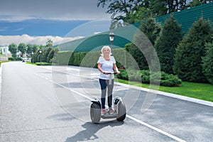 Senior woman driving electric personal transporter