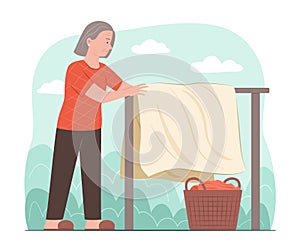 Senior Woman Drying Clothes on Clothesline in Garden