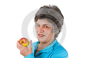 Senior woman eating apple