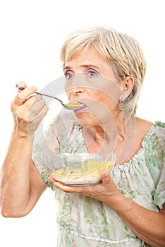 Senior woman eating cereals