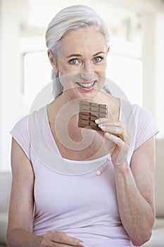 Senior Woman Eating Chocolate