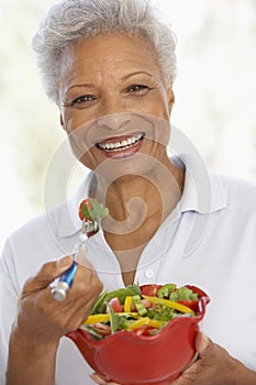 Senior Woman Eating A Fresh Green Salad photo