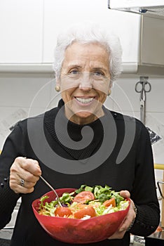 Senior woman eating a healthy salad