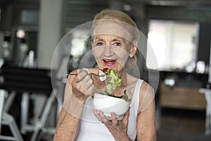 Senior woman eating healthy salad. elderly health lifestyle concept