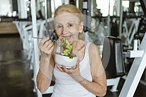 Senior woman eating healthy salad. elderly health lifestyle nutrition concept