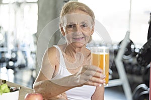 Senior woman eating healthy salad and orange juice. elderly health lifestyle nutrition concept