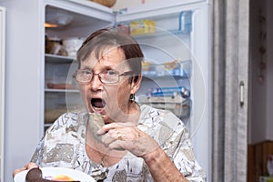 Senior woman eating pork liver sausage