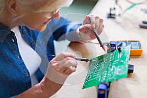 Senior woman in electronics workshop