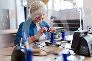 Senior woman in electronics workshop