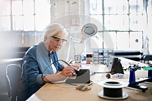 Senior woman in electronics workshop