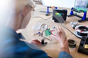 Senior woman in electronics workshop