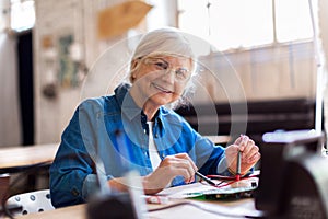 Senior woman in electronics workshop