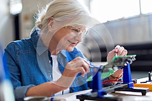 Senior woman in electronics workshop