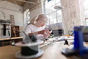 Senior woman in electronics workshop