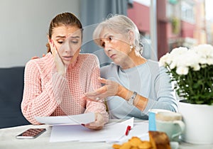 Senior woman encouraging daughter with financial problems