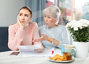 Senior woman encouraging daughter with financial problems