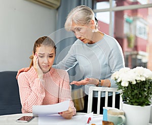 Senior woman encouraging daughter with financial problems