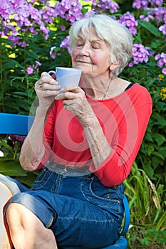 Senior Woman Enjoying the Aroma of her Coffee