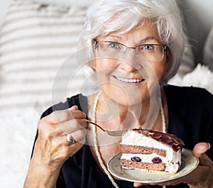 Senior woman enjoying cake