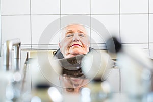 Senior woman enjoying mud bath