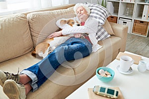 Senior Woman Enjoying Nap with Dog