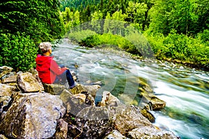 Senior Woman enjoying the View of Cayoosh Creek