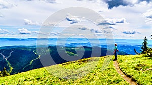 Senior Woman enjoying the view on a hike on Tod Mountain near the alpine village of Sun Peaks in the Shuswap Highlands, BC