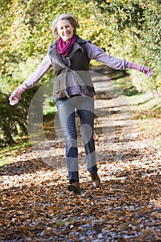 Senior woman enjoying walk through woods