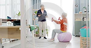 Senior woman, exercise ball and personal trainer in home, tablet or app for training advice, workout or health. Elderly
