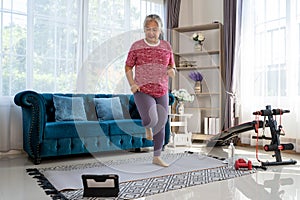 Senior woman exercise with jog in place at home