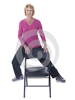 Senior woman exercising with chair