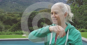 Senior woman exercising in a garden