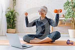 Senior woman exercising at home