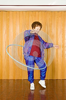 Senior woman exercising with a hula hoop