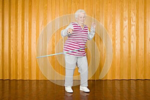 Senior woman exercising with a hula hoop