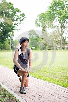 Senior woman exercising in park